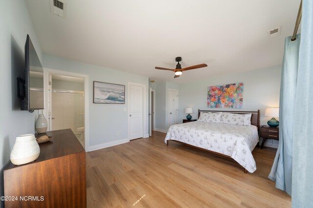 bedroom with light wood-type flooring, ensuite bath, and ceiling fan