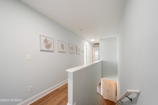 hallway with light hardwood / wood-style floors