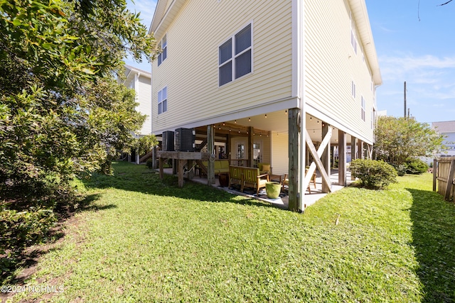 back of house with a lawn and a patio area