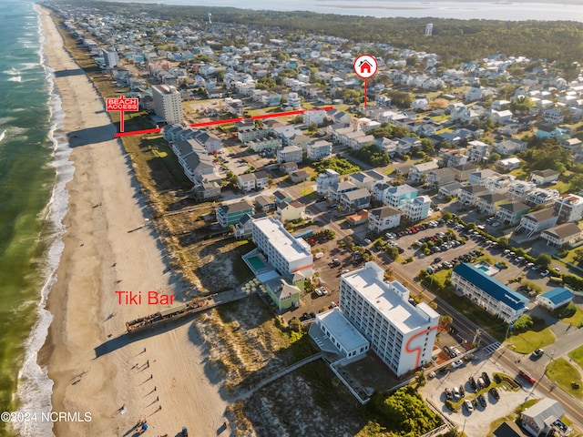 drone / aerial view featuring a water view and a beach view