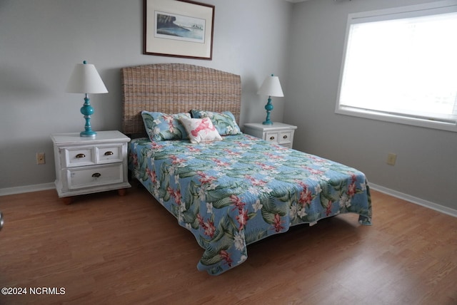 bedroom with hardwood / wood-style flooring