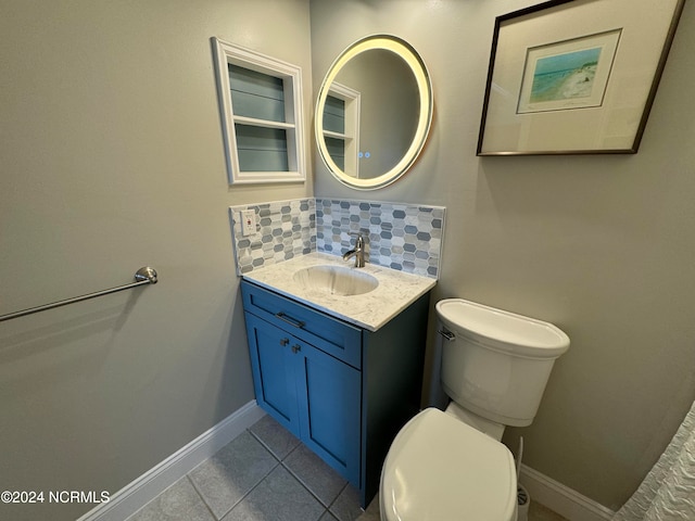 bathroom featuring vanity, tile patterned floors, toilet, and decorative backsplash