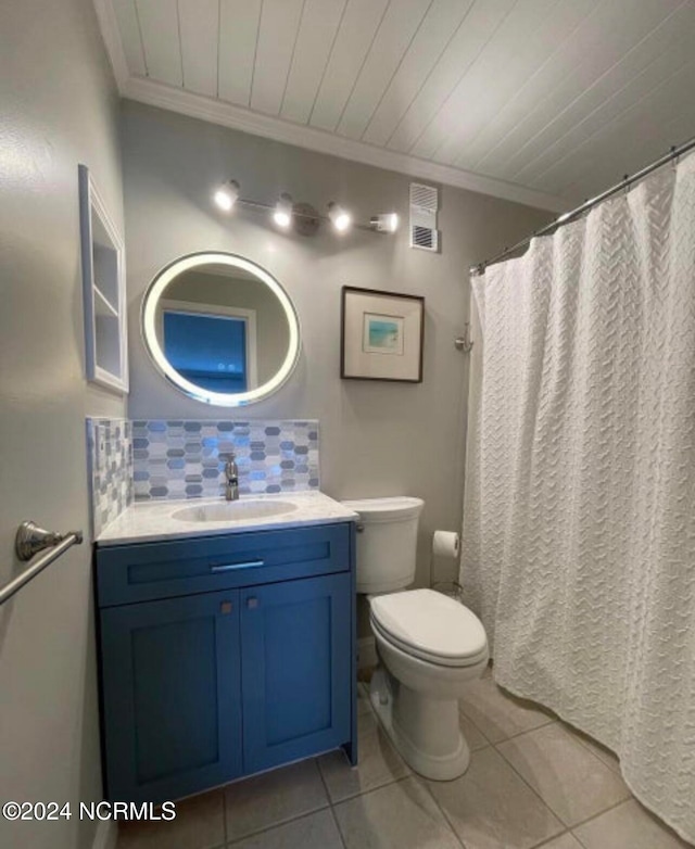 bathroom with toilet, crown molding, tile patterned floors, backsplash, and vanity