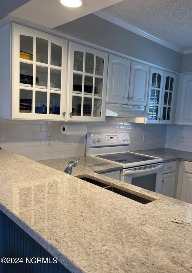 kitchen featuring white cabinets, ornamental molding, a textured ceiling, backsplash, and white electric range