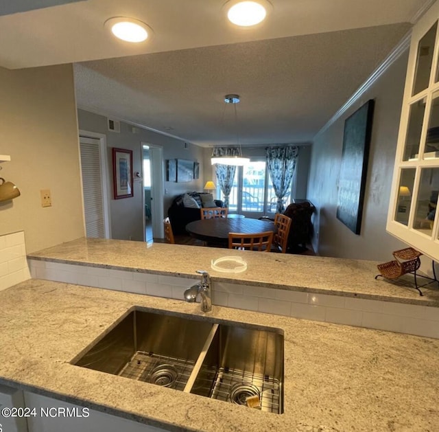 kitchen featuring sink and ornamental molding