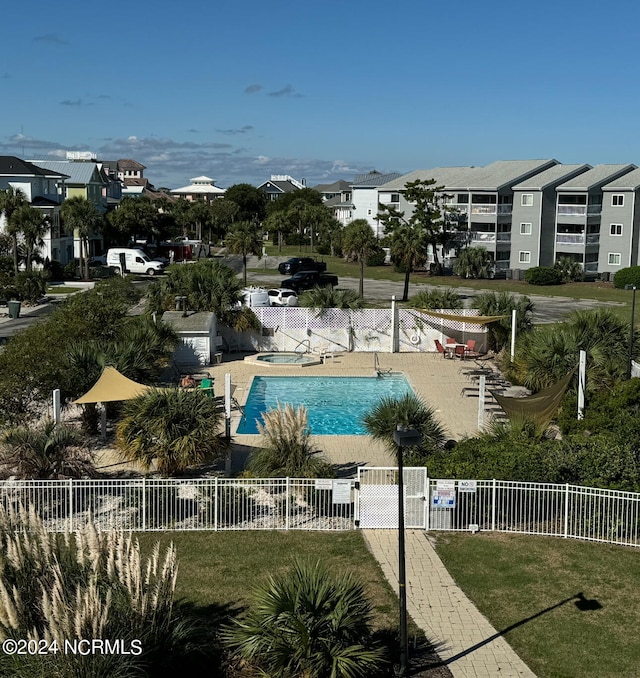 view of swimming pool with a lawn