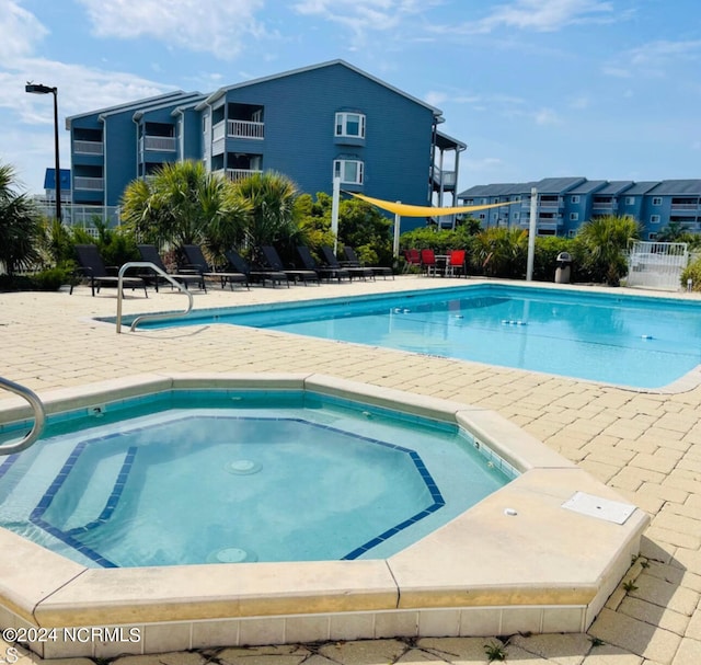 view of pool featuring a hot tub