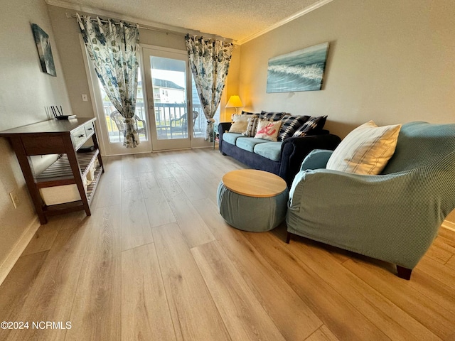 living room with crown molding, hardwood / wood-style flooring, and a textured ceiling