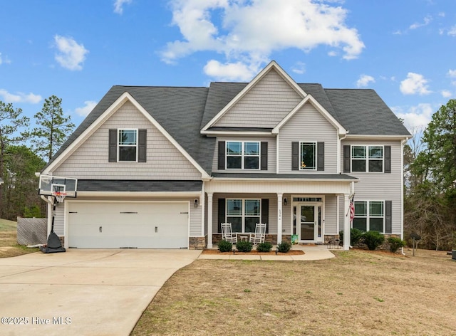 craftsman-style home featuring a garage, a front yard, and covered porch