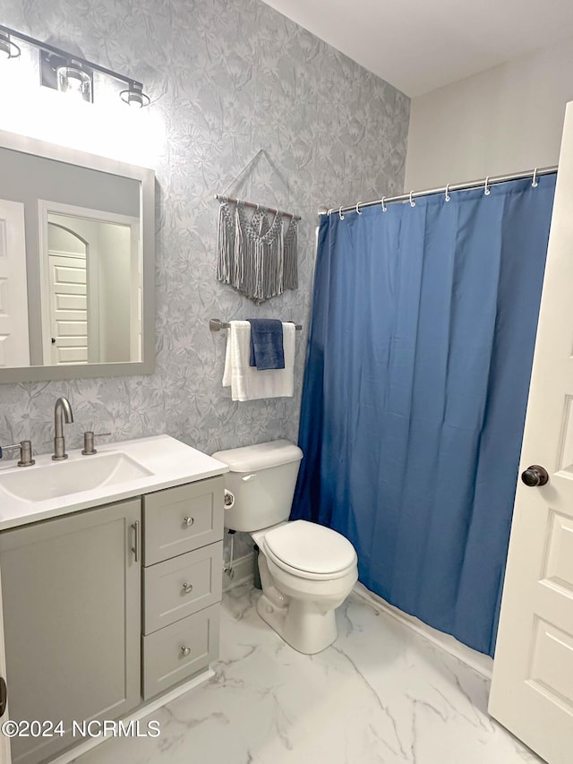 bathroom with vanity, curtained shower, and toilet