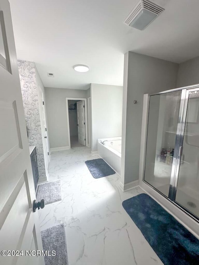 bathroom with vanity and separate shower and tub