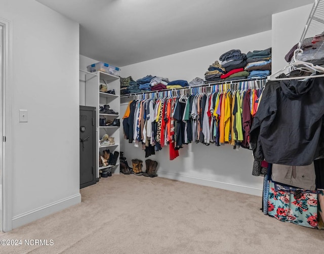 walk in closet featuring light carpet