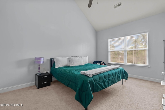 carpeted bedroom featuring high vaulted ceiling and ceiling fan