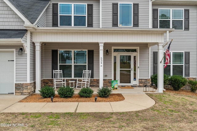 view of front facade featuring a porch and a garage