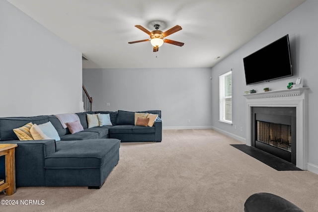 carpeted living room with ceiling fan