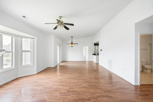 empty room with wood-type flooring, lofted ceiling, and ceiling fan