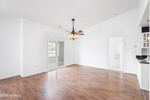 unfurnished living room with vaulted ceiling, ceiling fan, and hardwood / wood-style floors