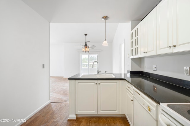 kitchen with white cabinets, sink, kitchen peninsula, dishwasher, and hardwood / wood-style floors