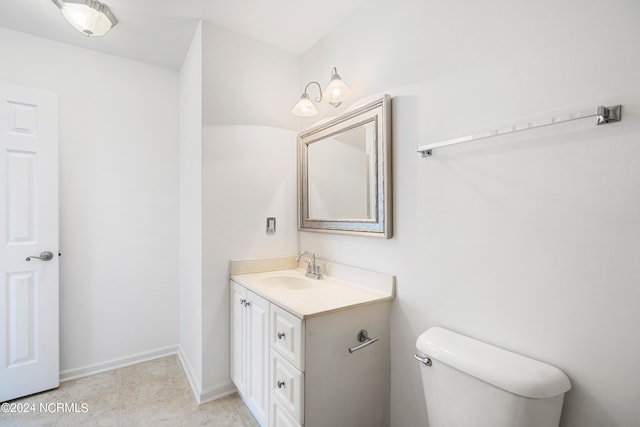 bathroom with vanity, toilet, and tile patterned floors