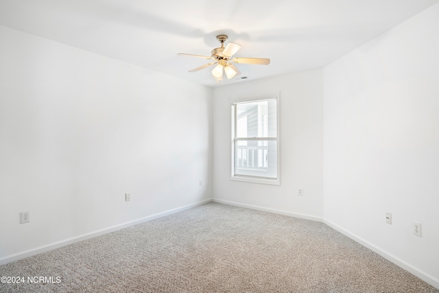 spare room with carpet floors and ceiling fan