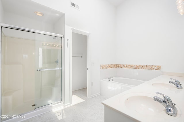 bathroom with independent shower and bath, tile patterned flooring, and sink