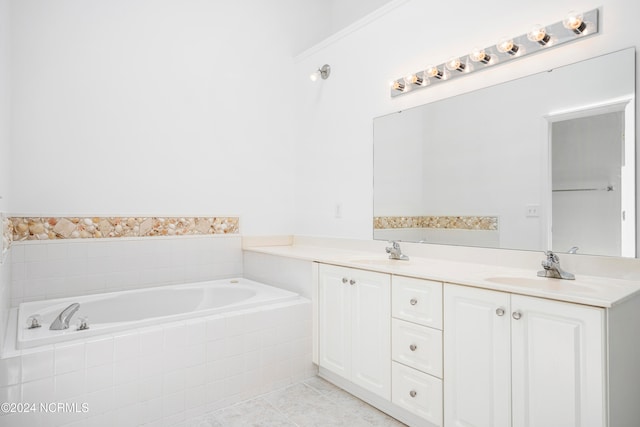 bathroom with tile patterned floors, tiled tub, and vanity