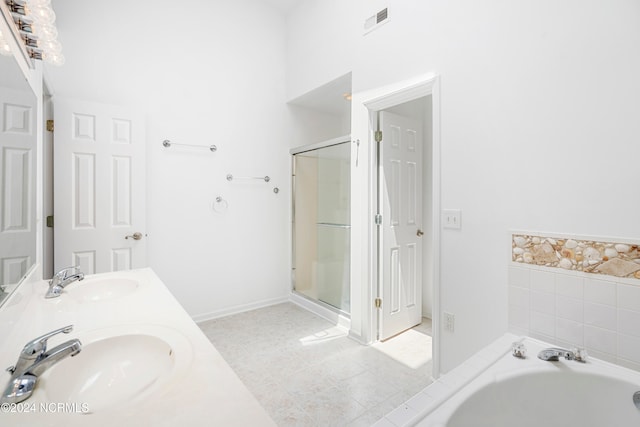 bathroom featuring vanity, independent shower and bath, and tile patterned floors