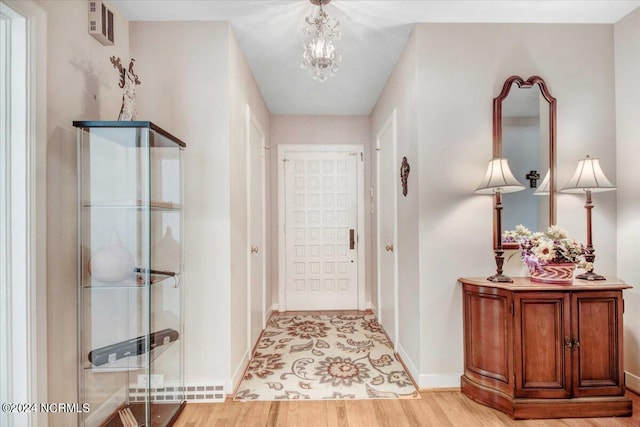 entrance foyer featuring an inviting chandelier and light hardwood / wood-style floors