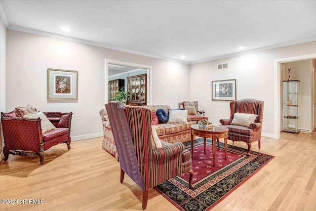 living room featuring crown molding and light hardwood / wood-style floors