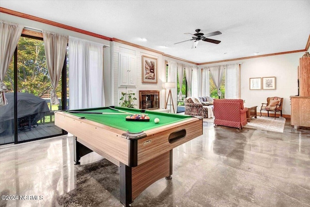 playroom featuring ceiling fan, a textured ceiling, pool table, a large fireplace, and crown molding