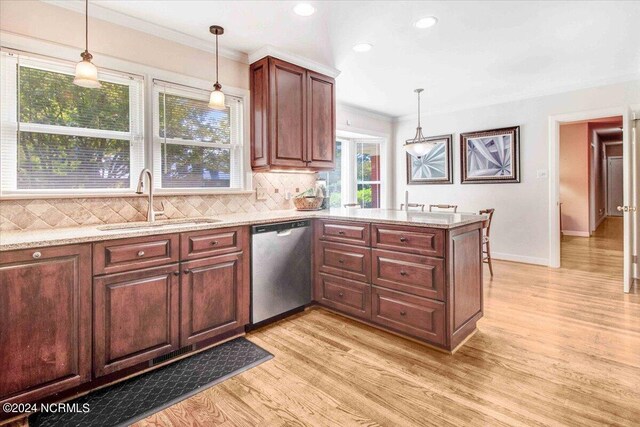 1803 Sedgefield Dr, Kinston, NC 28504 - kitchen with dishwasher, a sink, light wood finished floors, and decorative backsplash