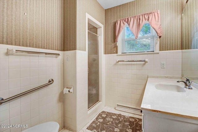 bathroom with vanity, toilet, walk in shower, tile walls, and tile patterned flooring