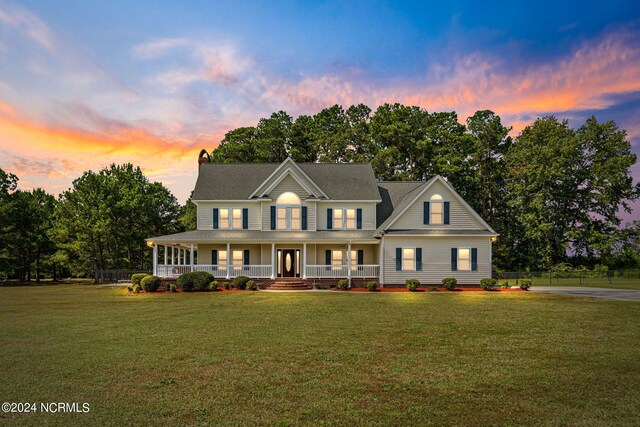 view of front of property with a yard and covered porch