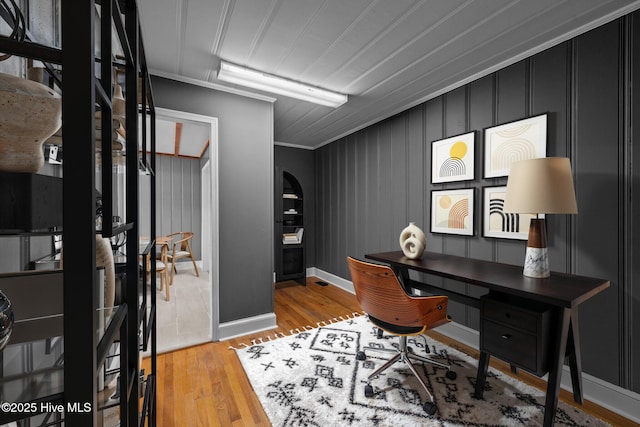 office area featuring crown molding and light wood-type flooring