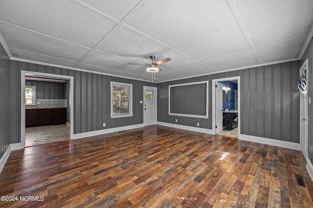 interior space featuring ceiling fan, dark hardwood / wood-style floors, and a healthy amount of sunlight