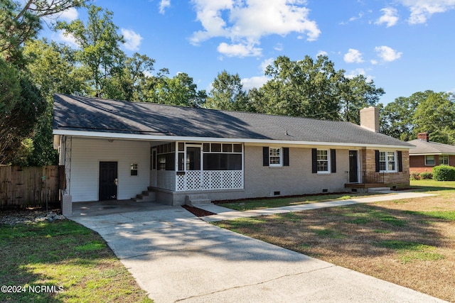 ranch-style home featuring brick siding, a chimney, crawl space, fence, and an attached carport