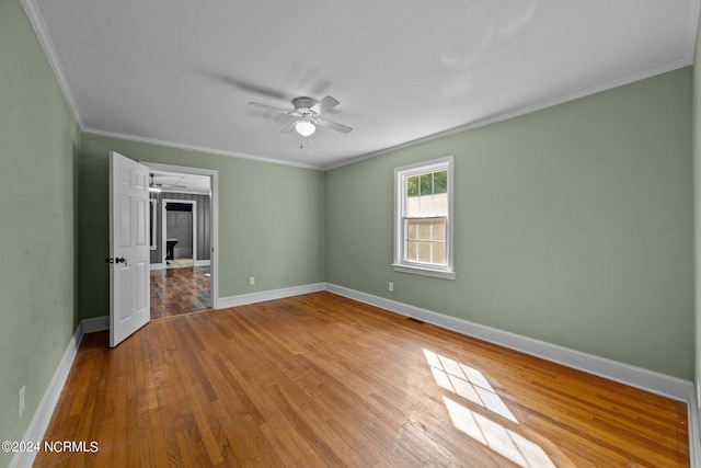 unfurnished bedroom with ceiling fan, ornamental molding, and light wood-type flooring