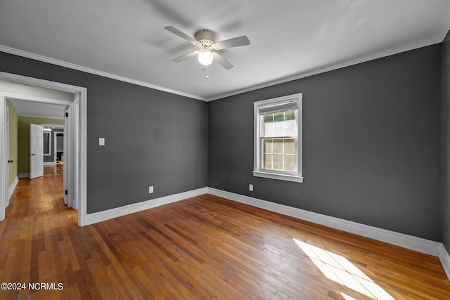 unfurnished room featuring crown molding, wood-type flooring, and ceiling fan