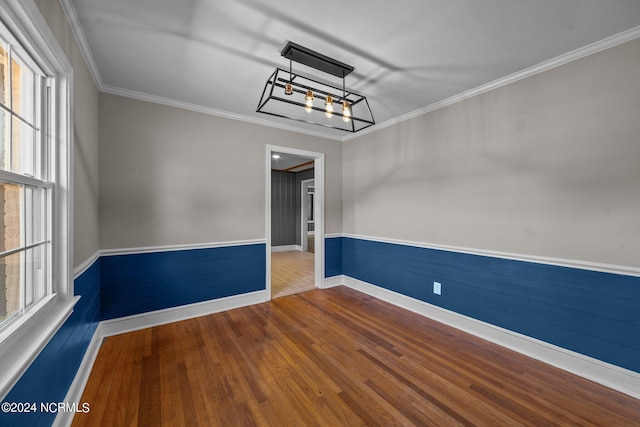 spare room featuring ornamental molding and plenty of natural light