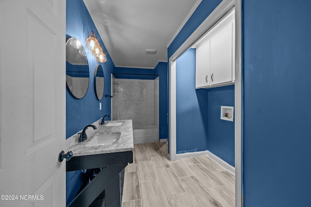 bathroom featuring vanity, a bath, and crown molding