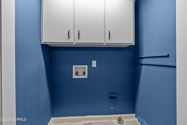 clothes washing area featuring cabinets and washer hookup