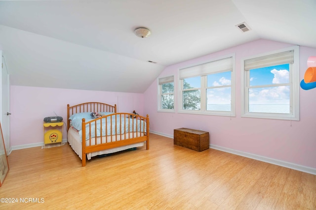 77 Indian Trl, Arapahoe, NC 28510 - bedroom with vaulted ceiling, light wood-style floors, and baseboards