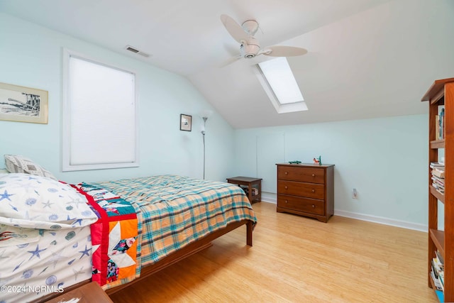 77 Indian Trl, Arapahoe, NC 28510 - bedroom featuring lofted ceiling, light wood finished floors, a skylight, ceiling fan, and baseboards