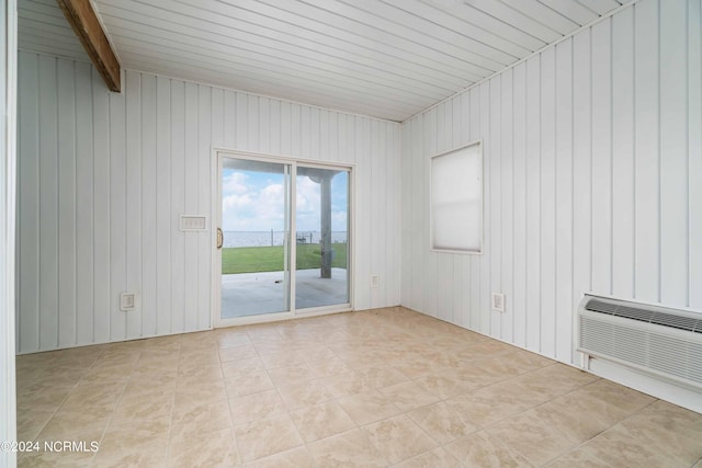 77 Indian Trl, Arapahoe, NC 28510 - unfurnished room with light tile patterned floors, wooden walls, and an AC wall unit
