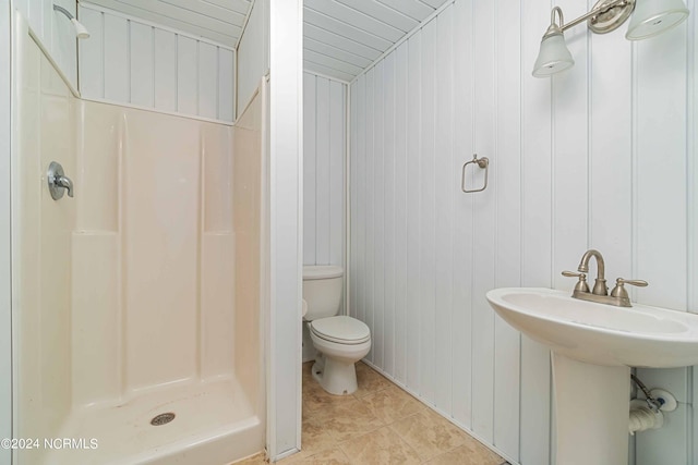 77 Indian Trl, Arapahoe, NC 28510 - bathroom featuring toilet, a shower stall, tile patterned floors, and wooden walls