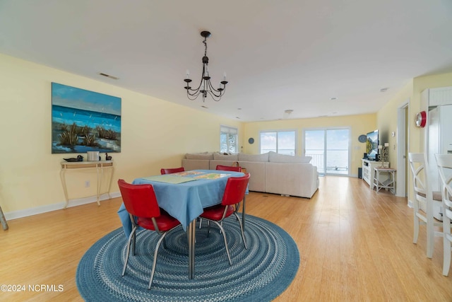 77 Indian Trl, Arapahoe, NC 28510 - dining space with a chandelier and light wood-style flooring