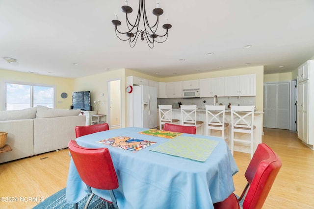 77 Indian Trl, Arapahoe, NC 28510 - dining area featuring light wood finished floors, a chandelier, and recessed lighting