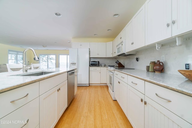 77 Indian Trl, Arapahoe, NC 28510 - kitchen with a sink, white appliances, light wood-style floors, white cabinets, and recessed lighting