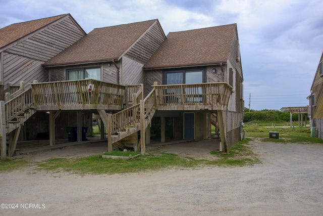 back of house featuring a wooden deck