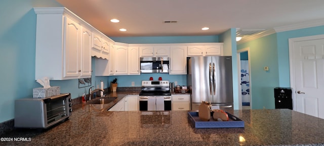 kitchen featuring appliances with stainless steel finishes, crown molding, sink, and white cabinets